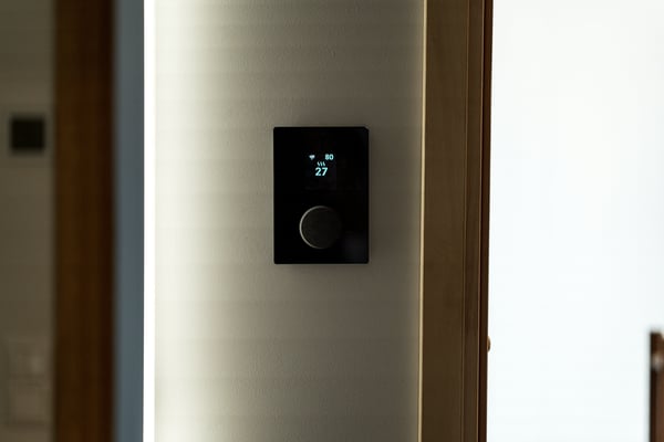 Modern smart thermostat mounted on a wall